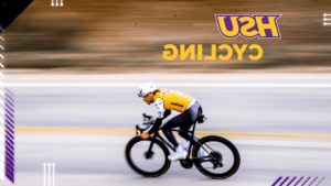 A photo of a cyclist wearing an HSU jersey.